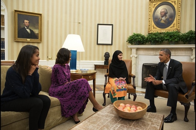 While BBC, The Washington Post and other international and U.S. media used this photo, the Voice of America (VOA), U.S. taxpayer-funded media outlet for international audiences, did not. President Barack Obama, First Lady Michelle Obama, and their daughter Malia meet with Malala Yousafzai, the young Pakistani schoolgirl who was shot in the head by the Taliban a year ago, in the Oval Office, Oct. 11, 2013. (Official White House Photo by Pete Souza)