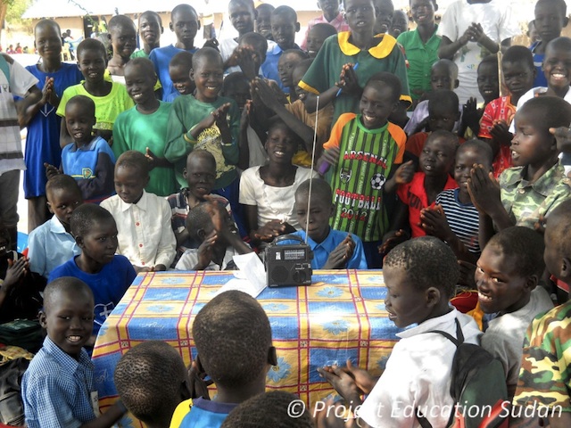 Students in South Sudan listen to their favorite shortwave radio program, VOA Learning English, with a self-powered radio supplied by Ears To Our World.